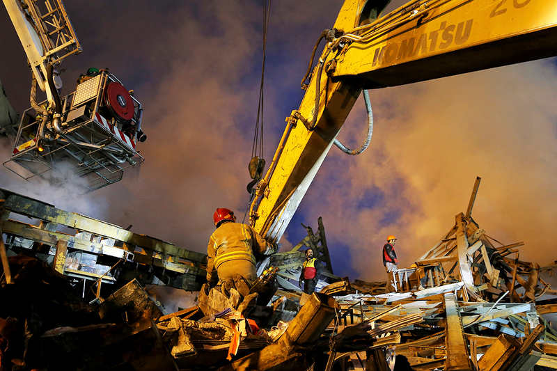 Iranian firefighters remove debris of the Plasco building which was engulfed by a fire and collapsed, in central Tehran, Iran. Photo: AP.